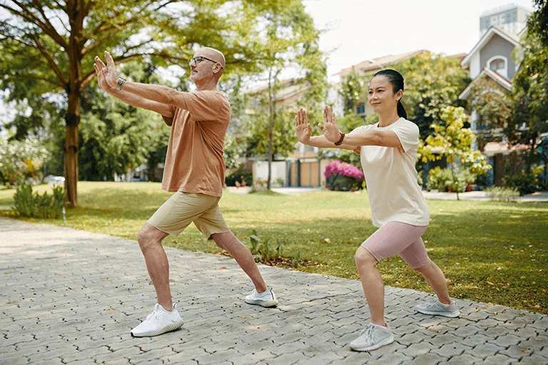 couple doing tai chi in park